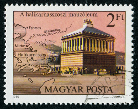Partenon on Greek Vintage Postage Stamp. The Parthenon  is a temple in the Athenian Acropolis, Greece, dedicated to the Greek goddess Athena, whom the people of Athens considered their protector. Its construction began in 447 BC and was completed in 438 BC, In the 1200's the Parthenon was converted to a Christian church and then converted into a Mosque in the 1400's.