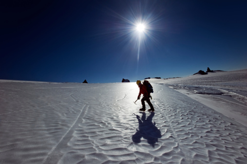 Male hiker on the south pole expedition walking on the frozen terrain.