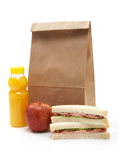 istock Lunch bag with sandwich, apple and orange juice 186870725