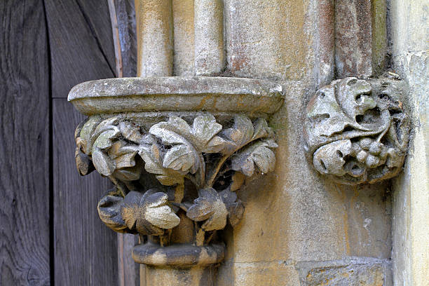 Acanthus decoration at the top of pillars or columns is a feature of both Greek and Roman classical architecture. Thedecorated  top of a column is referred to as its capital. The pillar shown here is part of a doorway to a church in Godstone, Surrey.