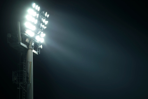 Stadium lights from side illuminating space for your text. Flies flying around the lights.My other similar images in