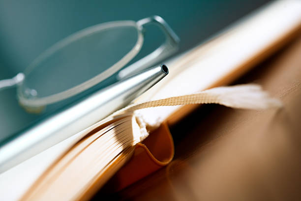 istock Old book, glasses and pen 186871318