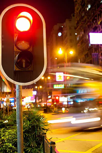 Red traffic signal at night in the streets of Hong Kong