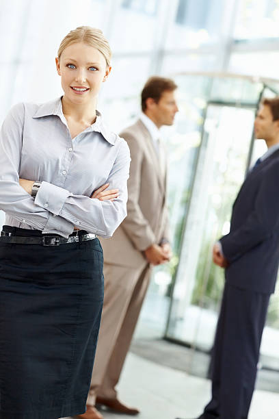 istock Beautiful business woman with arms folded at workplace 186871458
