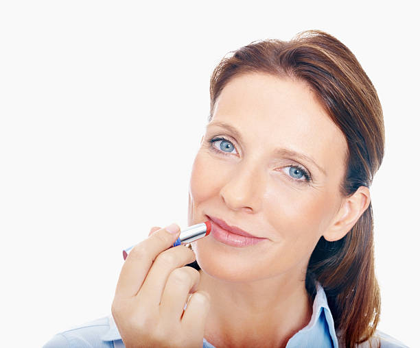 istock Modern pretty female applying red lipstick 186872258