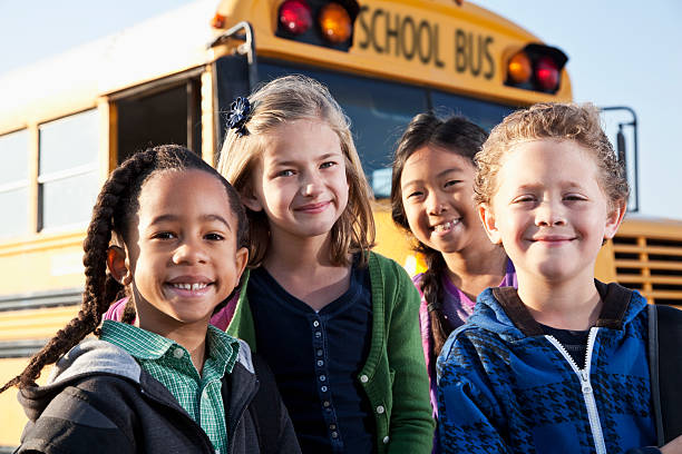 istock Children standing outside school bus 186872405