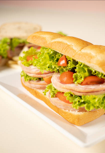 istock Sandwich Ham with salad tomato on white plate 1868727484