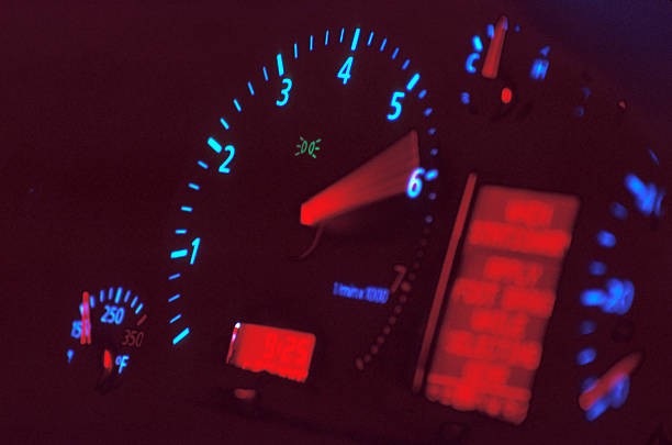 RPM (2) Second of two.  This one has less blur on the tachometer needle.  Time-lapse, cross-processed exposure of a redlining tachometer.  For those curious, the tachometer is from an Audi A4.  Shot on C41 film cross processed as E6 with a Canon EOS SLR.  Very high quality. Revving stock pictures, royalty-free photos & images