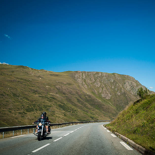 istock Motorcyclist driving along a high mountain road 186873048