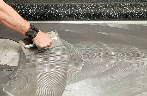 istock Troweling Adhesive for Recycled Rubber Floor 186873069