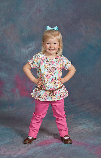 Young Girl School / Yearbook Portrait Age 3 Standing Standing portrait of a three-year-old girl against a studio background.  Model is smiling and quite happy.See other related images here: school picture stock pictures, royalty-free photos & images