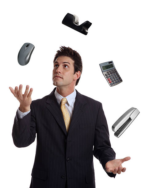 istock Businessman Juggling Office Supplies 186874288