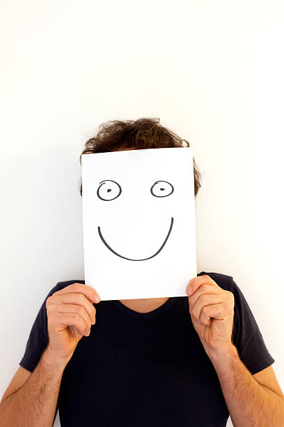 istock Man Holding a Blank Paper with Smiley Face 186875397