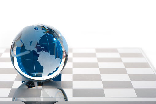 Globe on a chess board showing The Americas