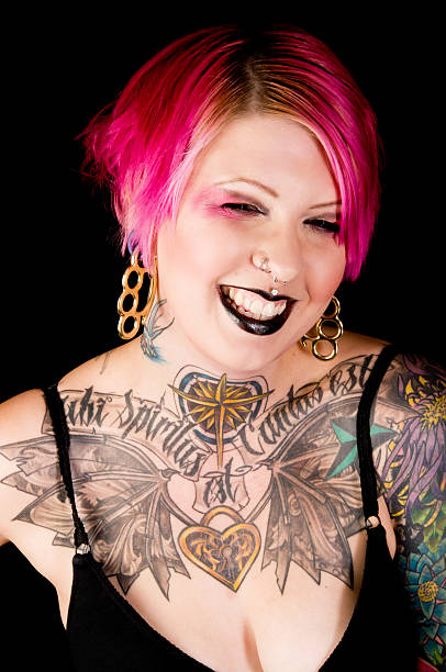 istock Tattooed woman laughing with eyes squinting. 186876282
