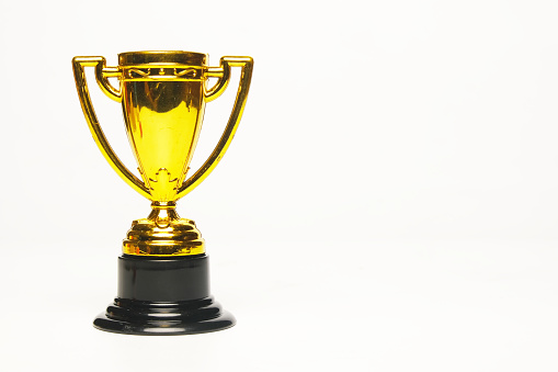 A picture of golden trophy on copyspace white background.