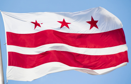 A closeup of the red and white flag of the District of Columbia also known as Washington DC or the Nations Capital.  This flag was blowing in a stiff breeze.