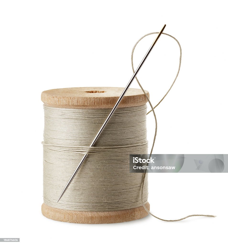 thread and needle spool of thread with needle isolated on white Thread - Sewing Item Stock Photo