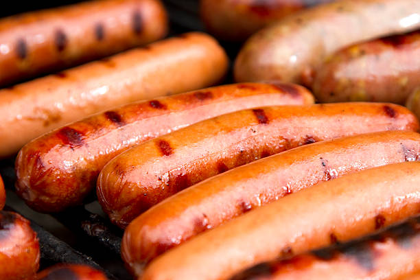 Close up of grilled hotdogs on grill Juicy hot dogs on the grill. hot dog photos stock pictures, royalty-free photos & images