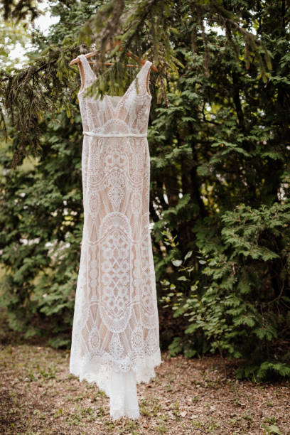 istock full length lace wedding dress hanging from a tree branch 1868767391