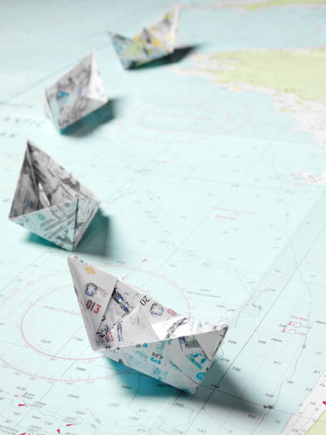 istock Origami Boats Sailing on a Nautical Chart 186876805