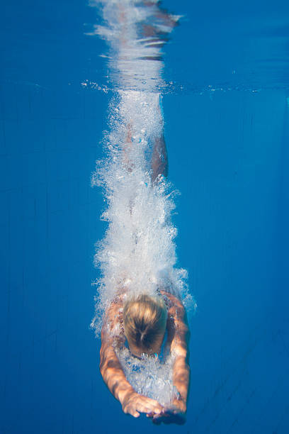 istock Young woman diving 186876890