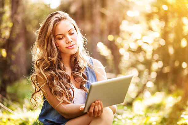 istock Young woman uses digital tablet 186878885
