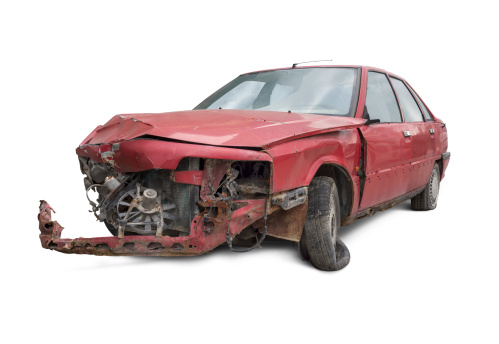 Old and damaged red car isolated on white background.