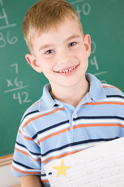 istock Proud student holding paper with star 186879616