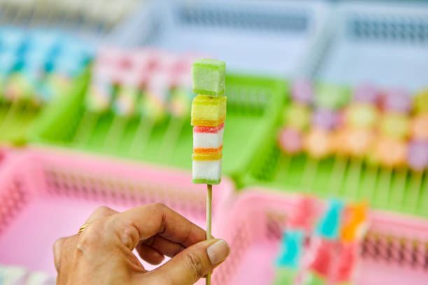 Cropped hand holding skewer jelly candies in Bangkok, Bangkok, Thailand