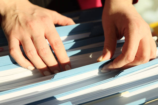 istock Secretary looks for folder with accounting papers in archive 1868805157