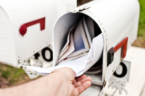 Male human hand getting the mail