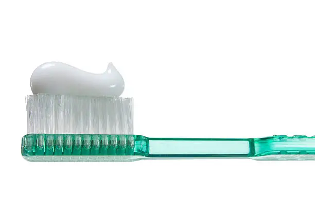 Photo of Close-up of green translucent toothbrush with toothpaste