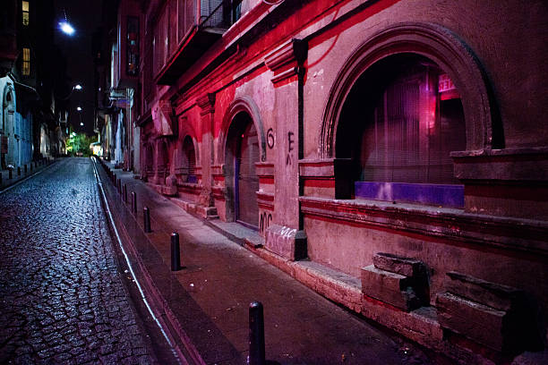 An alley in Istanbul, Turkey lit with ambient street lights and colorful buildings.