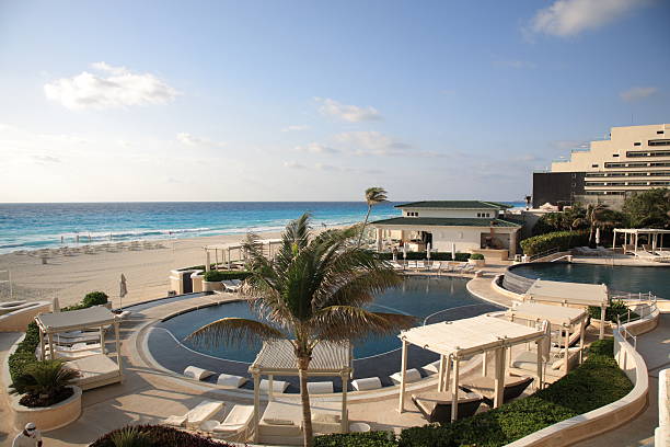 A Mexican holiday villa overlooks the turquoise Caribbean Sea on the beach in Cancun, Mexico.