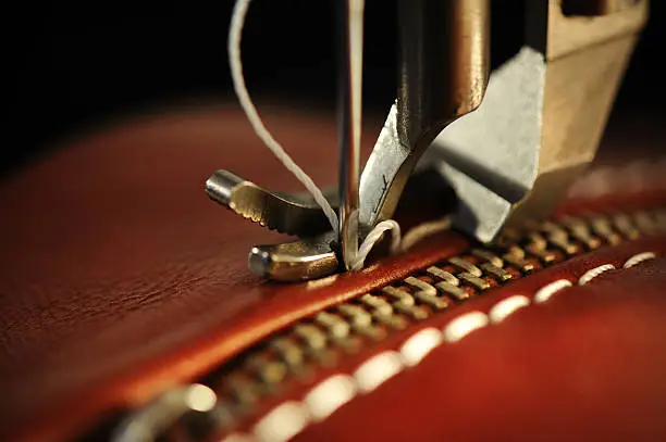 Macro, close-up of needle penetrating leather