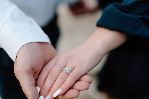 istock Engaged couple holding hands showing the diamond ring 1868816563