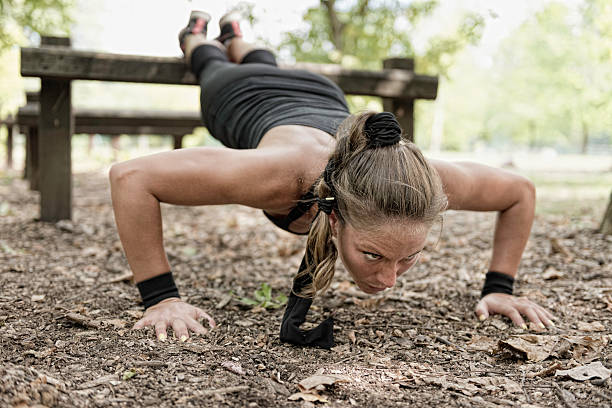 femme athlète faisant push ups - athlete push ups muscular build female photos et images de collection