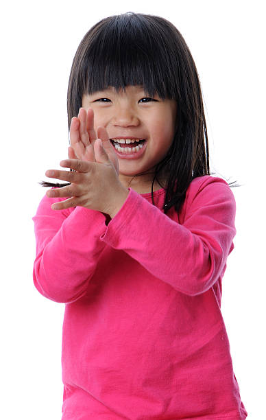 Smiling Girl Clapping Her Hands stock photo