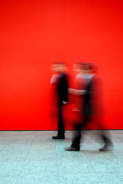 istock Two Businessmen Walking Through Office Hallway,  Blurred Motion 186883217