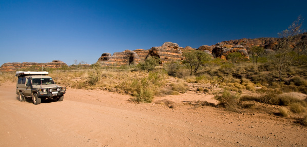 A 4WD vehicle cruising the dirt tracks in Purnululu National Park in Western Australia's Kimberley region.