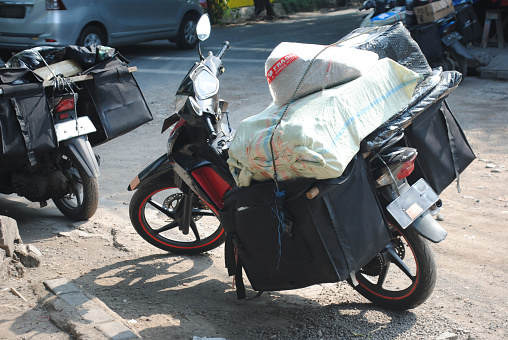 Package delivery person's motorbike in Indonesia.