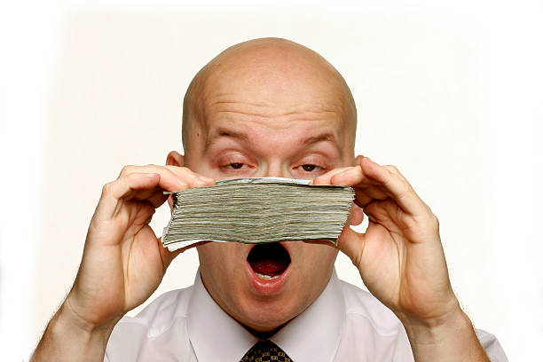 istock Mature business man holding cash 186885074