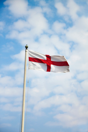 United Kingdom British flag flying in the wind with a blue sky background and copy space