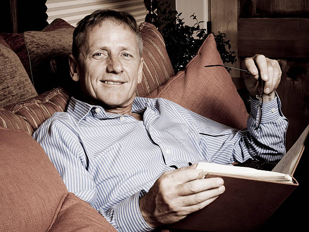 istock Man reading book in Living Room 186885393