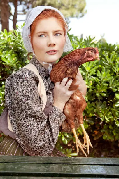 Amish woman posing with hen