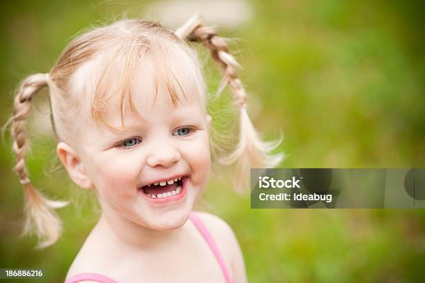 Happy Little Blonde Girl Laughing Outside Stock Photo - Download Image Now - 2-3 Years, Blond Hair, Blue Eyes