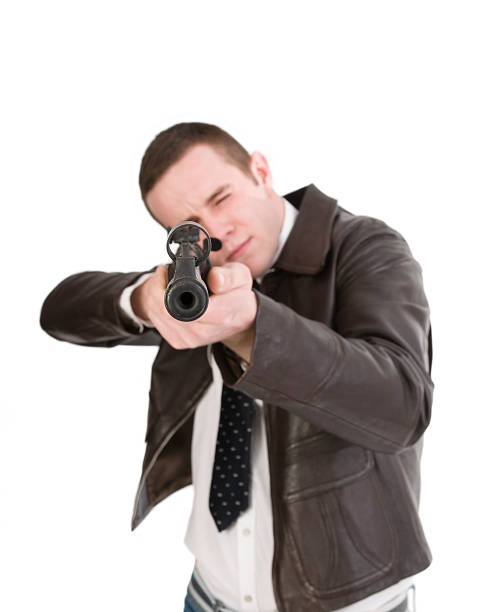 istock Young man pointing gun at you 186886562