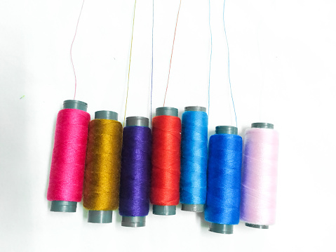 Colorful threads on white background.