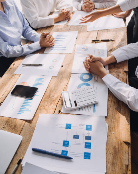 istock Financial analysts analyze business financial reports on a digital tablet planning investment project during a discussion at a meeting of corporate showing the results of their successful teamwork. 1868911343